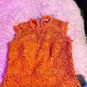 Cute orange blouse with zipper in the back lace with an under lining